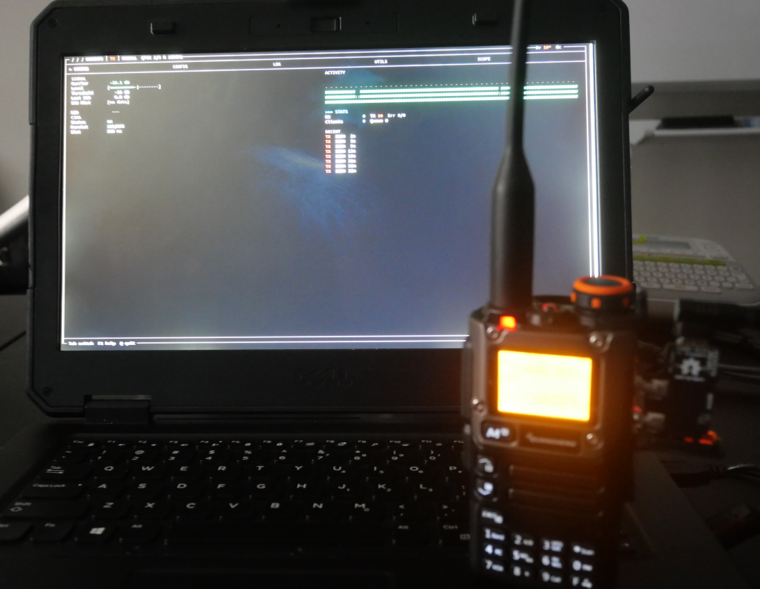 modem73 running on a laptop connected to a handheld radio with an AIOC